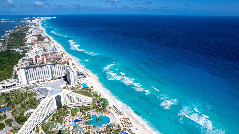Beautiful aerial perspective of Cancun's Hotel Zone as seen from El Mirador, featuring turquoise water and sandy beaches