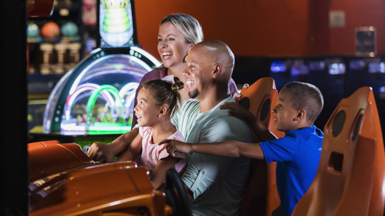 Family playing arcade games together