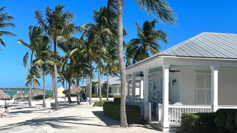 a cottage with a porch directly on the beach